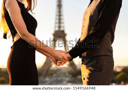 Couple in love, marriage proposal in Paris, romantic date near the Eiffel tower, honeymoon in France