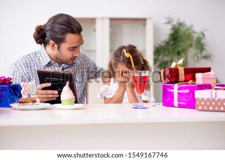 Father celebrating birthday with his daughter