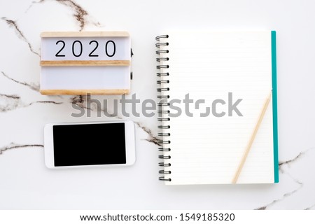 2020 wood box, blank notebook paper, smart phone with blank screen on white marble background, 2020 new year mock up, template, flat lay