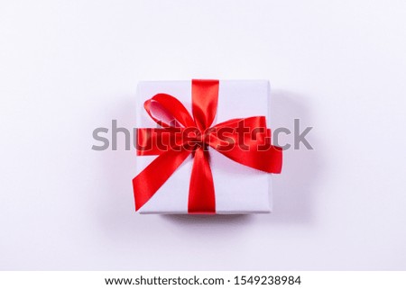 Christmas gift with red bow on white background. Xmas template. Happy New Year. Boxing Day.