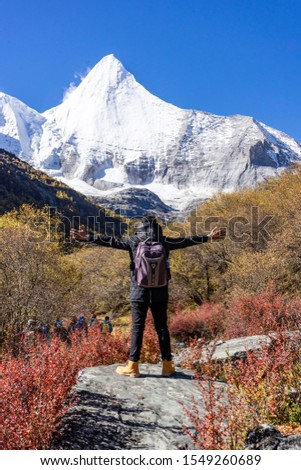 People with autumn colour landscape in Yading nature reserve