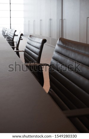 Meeting room professional board room lit by natural light chairs and table