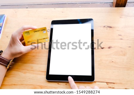 Close up of man using blank cell laptop and credit card sending massages shopping online on the coffee shop.