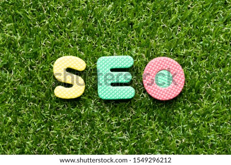Toy foam letter in word SEO (Abbreviation of search engine optimization) on green grass background