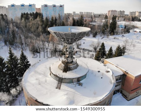 Aerial view of large abandoned satellite antenna of telescope radio in forest