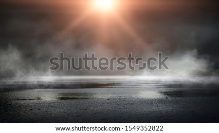 Wet asphalt, reflection of neon lights, a searchlight, smoke. Abstract light in a dark empty street with smoke, smog. Dark background scene of empty street, night view, night city. Royalty-Free Stock Photo #1549352822