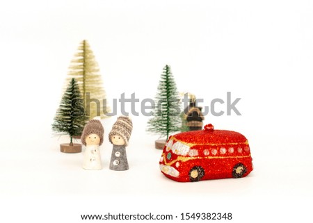 Christmas card with wooden toy dolls, Christmas trees and a red Golden handmade machine on a white background.
