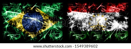 Brazil, Brazilian vs Tajikistan, Tajikistani New Year celebration sparkling fireworks flags concept background. Combination of two states flags.
