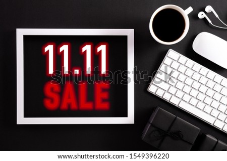 Online shopping of China, 11.11 singles day sale concept. Top view of  White picture frame with keyboard mouse coffee cup and gift box on black background. Online Shopping concept.