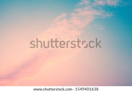 a cloud floats across the sky, the delicate colors of blue and pink Royalty-Free Stock Photo #1549401638