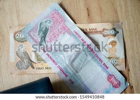United Arab Emirates Dirham with wallet on wood table