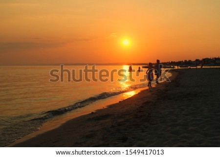 Happy moments of people on the beach at sunset