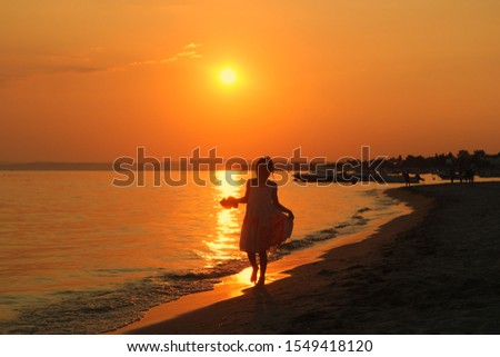 Happy moments of people on the beach at sunset
