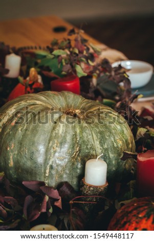 Fall thanksgiving decor with candle and pumpkins close up