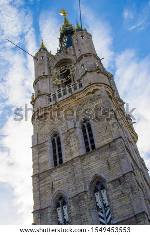 Vertical picture of the medieval tower of the Belfry (Het Belfort) of Ghent, in Belgium, Europe, during a sunny day. Tallest bell tower in Belgium with 91-meters high
