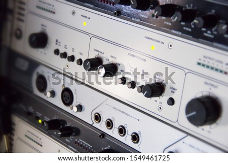 A rack of audio compressors and other components of sound reinforcement system in a recording studio close up. Making music in the professional studio