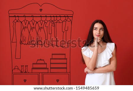 Thoughtful young woman imagining interior of dressing room
