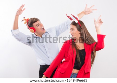 Portrait of happy couple in Christmas headband dancing on white background with copy space ,fun and happy smile on face  Happy New Year 2020 celebration holiday concept.