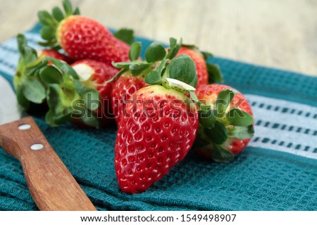 pile of strawberries on a wooden table