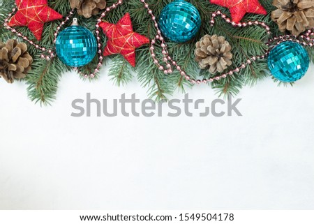 Christmas border made of fir branches, festive red decoration. Flat lay. top view with copy space. Christmas background