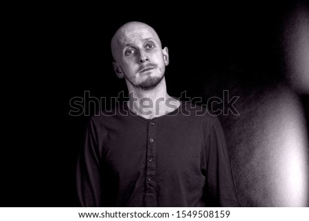 sad young man look into camera black white