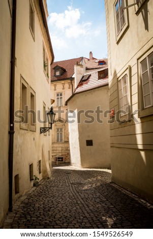Narrow cobbled street in Prague Royalty-Free Stock Photo #1549526549