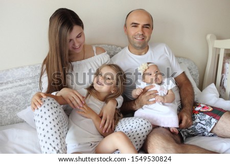 A young family with childrens to bed in the bedroom