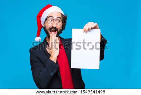 young crazy bearded man with santa hat. Christmas concept