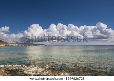Storm clouds on the horizon, with a calm sea