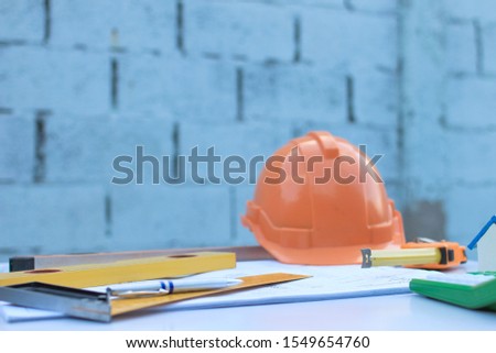 Desk of Architectural working home project in construction site,With drawing equipment concept.