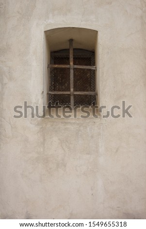 Latticed window in the wall of a Catholic church