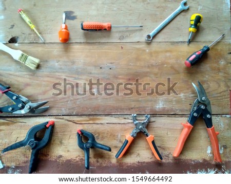 Flat lay composition with carpentry tools on rough wooden background. Top view workbench with carpenter different tools. Woodworking, craftsmanship, handwork, house, repair maintenance concept