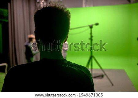 Actors and Crew in Modern Film Studio Recording with Green Screen and Light Equipment - Photo	