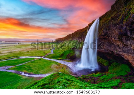 Sunrise on Seljalandfoss waterfall on Seljalandsa river, Iceland, Europe. Amazing view from inside. Landscape photography