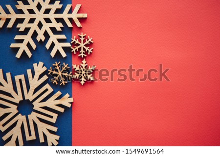 Winter holiday background.Christmas and Happy New Year wallpaper template with empty space for text.Hand made wooden snowflakes in flat lay poster.Hand crafted snow flake objects for home decoration