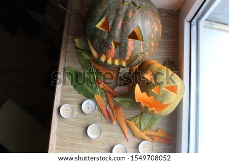 two pumpkins on a windowsill for Halloween
