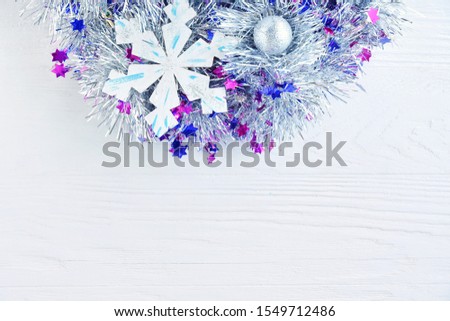 New Year 2020 flat lay with silver Christmas wreath with sparkle ball and wooden snowflakes on textured background, selective focus. Christmas and New Year flat lay with shiny decorative element 