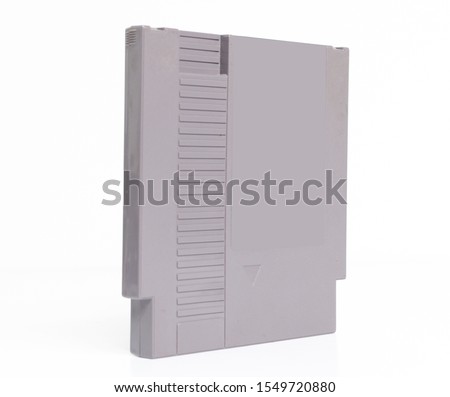 A blank for mockup retro vintage nintendo entertainment system NES console game cartridge isolated on a white background. iconic 1980s video game history and collectables.