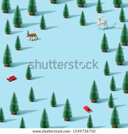 Trendy Christmas pattern made with various winter and New Year objects on bright light blue background. Minimal Christmas concept.
