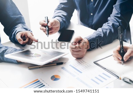 Asian business adviser meeting to analyze and discuss the situation on the financial report in the meeting room.Investment Consultant,Financial Consultant,Financial advisor and accounting concept Royalty-Free Stock Photo #1549741151