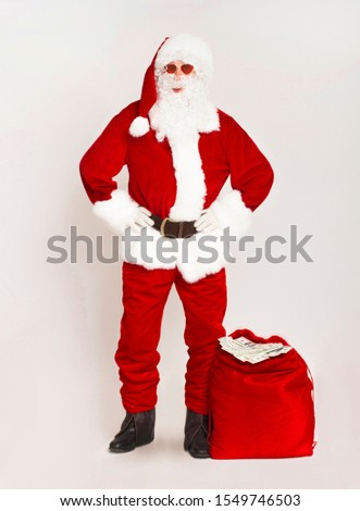 Who wants to be Santa. Rich man in costume with red sack full of dollars on white background