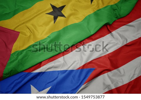waving colorful flag of puerto rico and national flag of sao tome and principe . macro