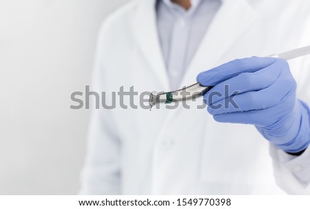 Professional equipment in modern stomatology, close up of dentist hand holding dental drill, empty space Royalty-Free Stock Photo #1549770398