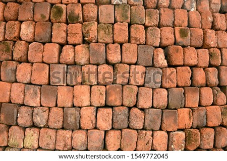 A brick wall built by human workers.