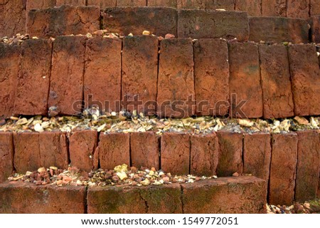 A brick wall built by human workers.