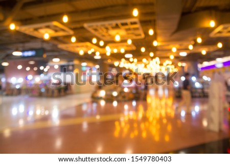 Abstract blurred department store interior background. Blur aisle of supermarket or warehouse for backdrop and design element use. Defocused background with bokeh light.