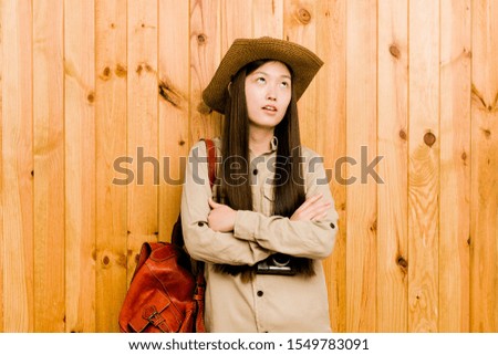 Young chinese traveler woman tired of a repetitive task.