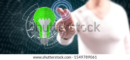 Woman touching a green energy concept on a touch screen with her fingers