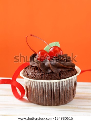cupcake with chocolate ganache  and cherries 