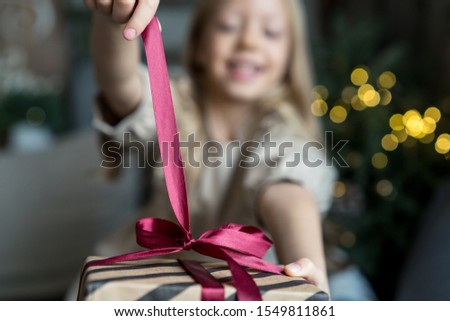 Happy girl ready to open christmas gift
